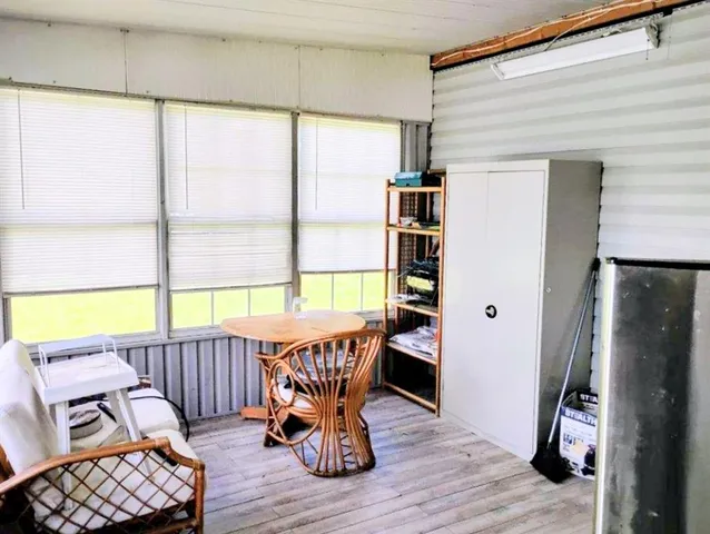 a view of front door with furniture and a window