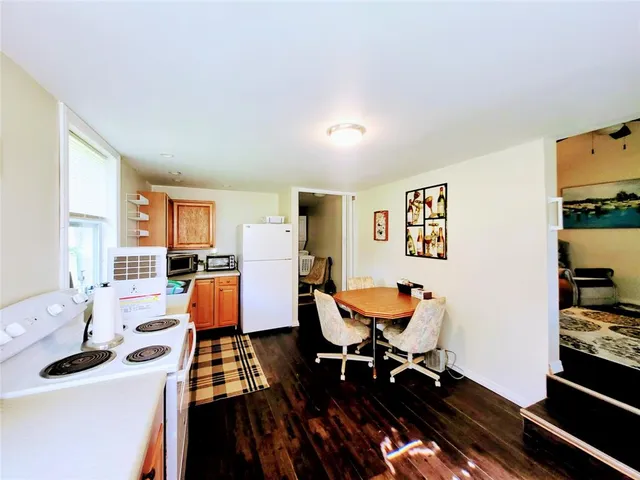 a kitchen with stainless steel appliances kitchen island granite countertop a refrigerator and a stove top oven