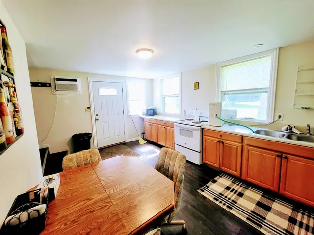 a kitchen with stainless steel appliances a refrigerator sink and window