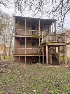 front view of a house with a large tree