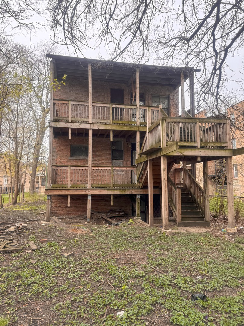 7431 South Kimbark Avenue Chicago, IL 60619 - Photo 4 of 12 front view of a house with a large tree