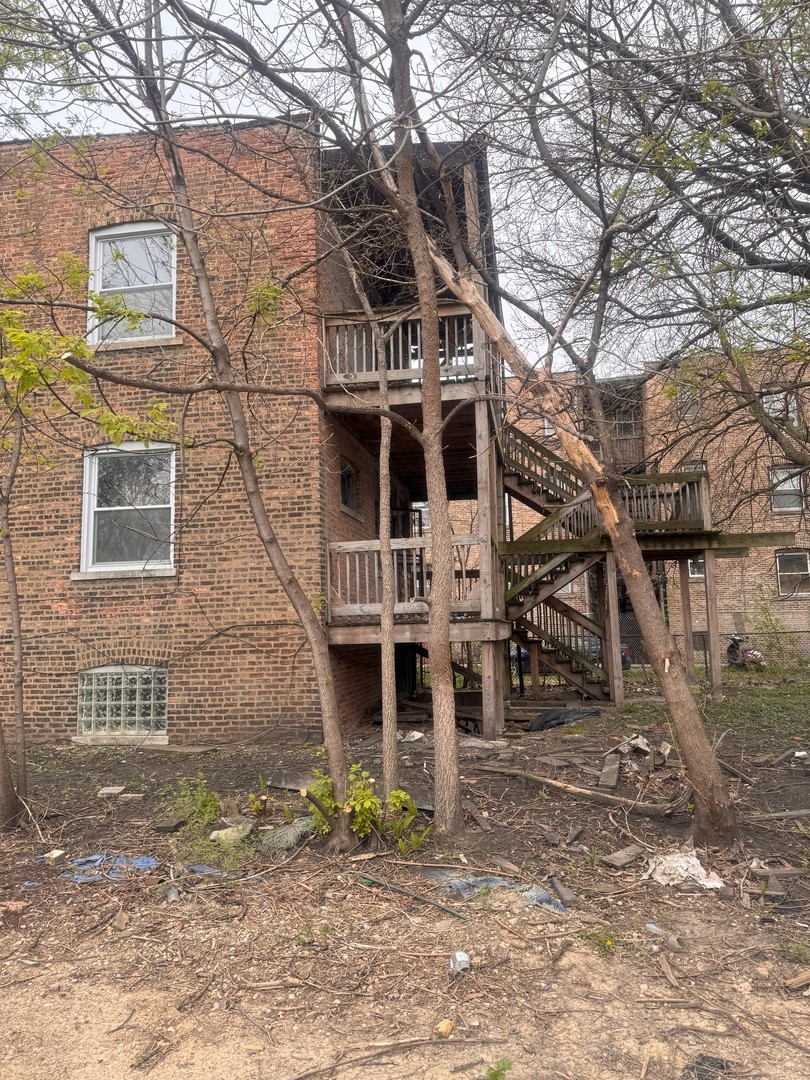 7431 South Kimbark Avenue Chicago, IL 60619 - Photo 5 of 12 a front view of a house with large trees