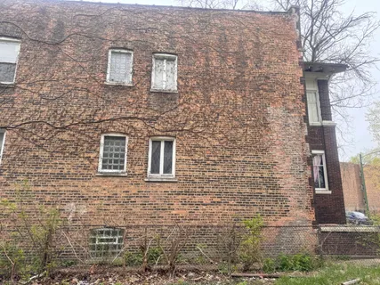 a brick building with a street sign on it