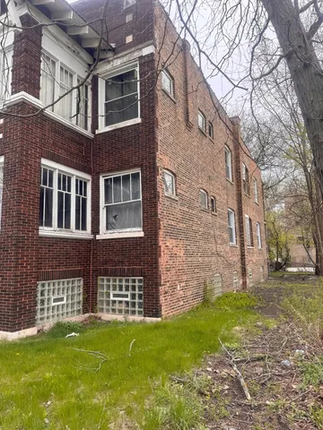 a brick building with a yard in front of it