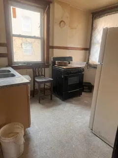 a living room with a stove and a window