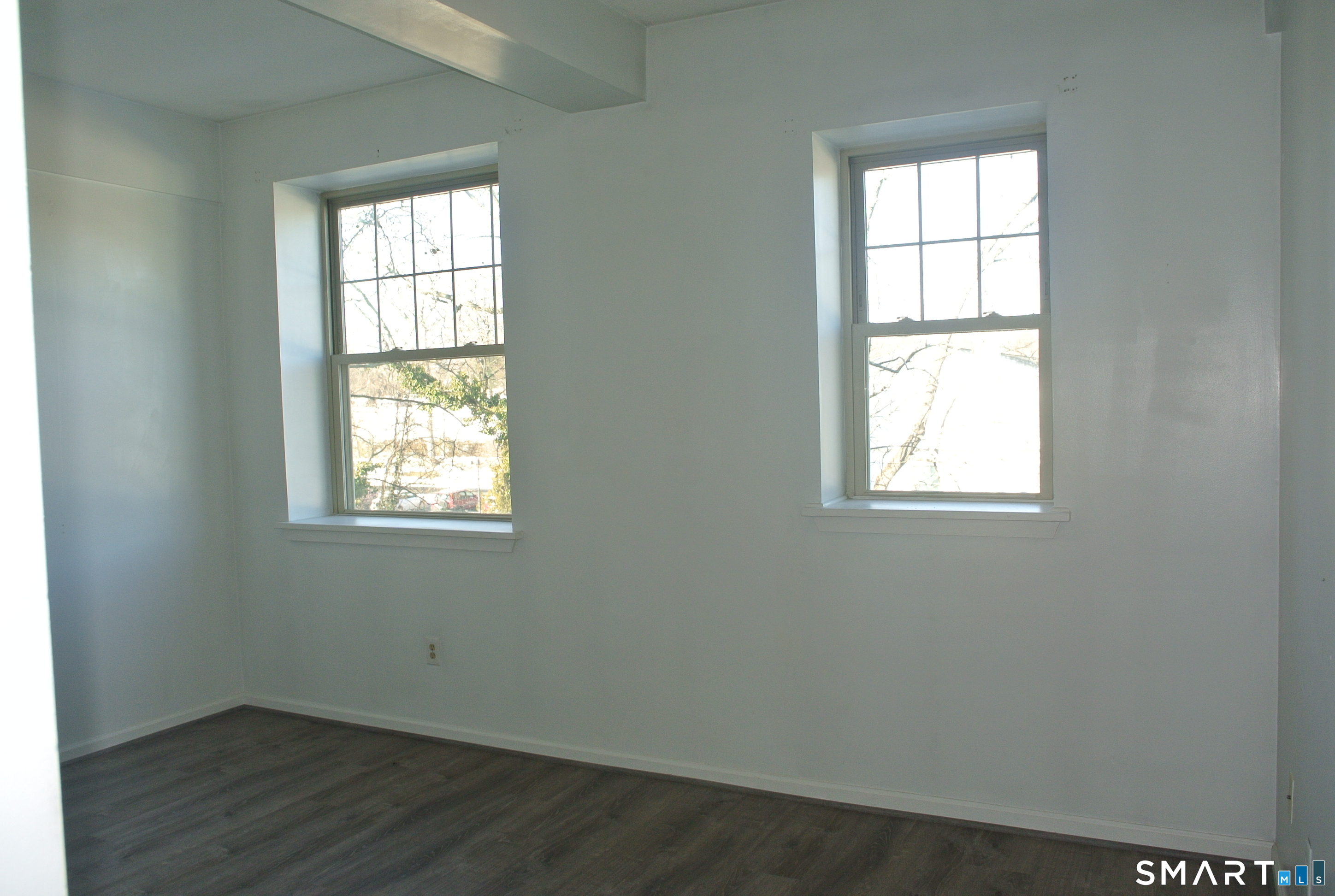 146 High Street, Unit 303 Milford, CT 06460 - Photo 14 of 17 an empty room with wooden floor and windows