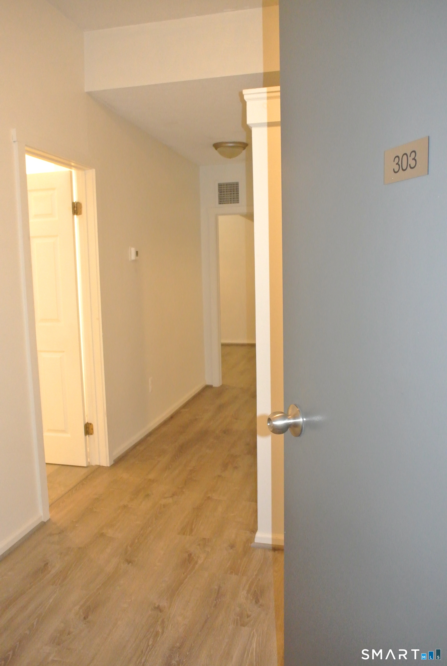 146 High Street, Unit 303 Milford, CT 06460 - Photo 2 of 17 an empty room with a door