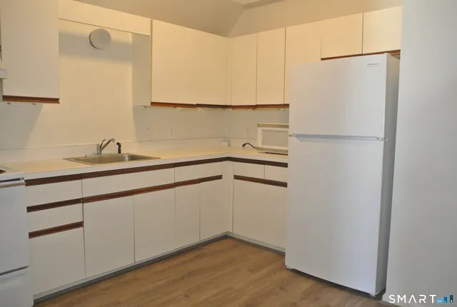 a kitchen with a sink and a refrigerator