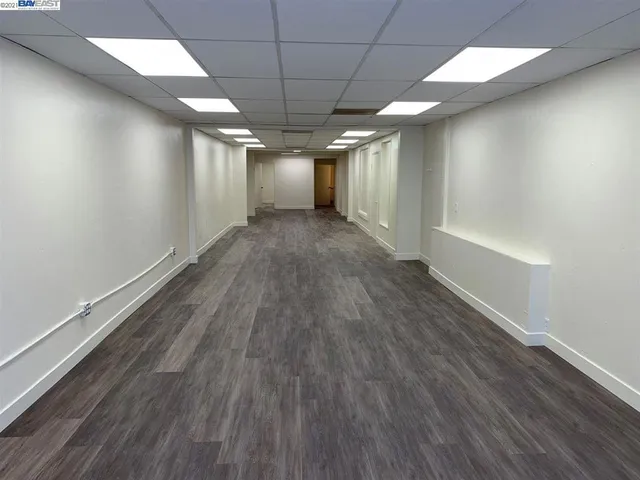 an empty room with wooden floor