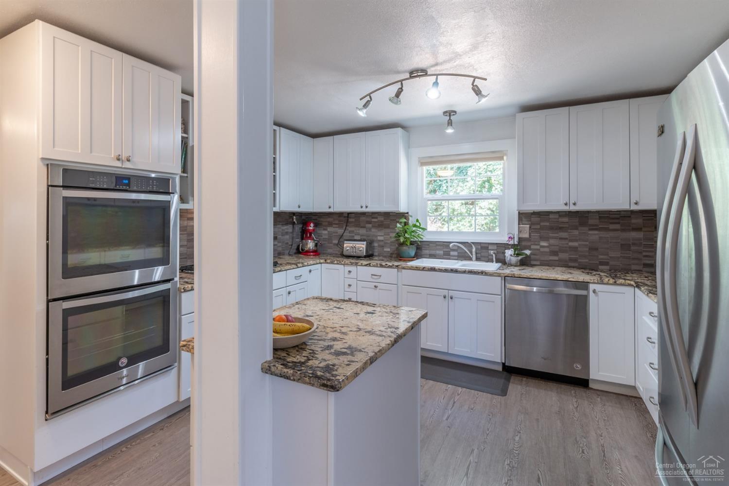 660 Level Lane Springfield, OR 97477 - Photo 17 of 23 a kitchen with a refrigerator and a stove top oven