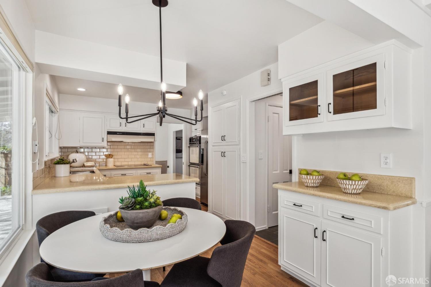 4 La Cuesta Road Orinda, CA 94563 - Photo 13 of 50 a kitchen with stainless steel appliances granite countertop a sink a stove a dining table and chairs