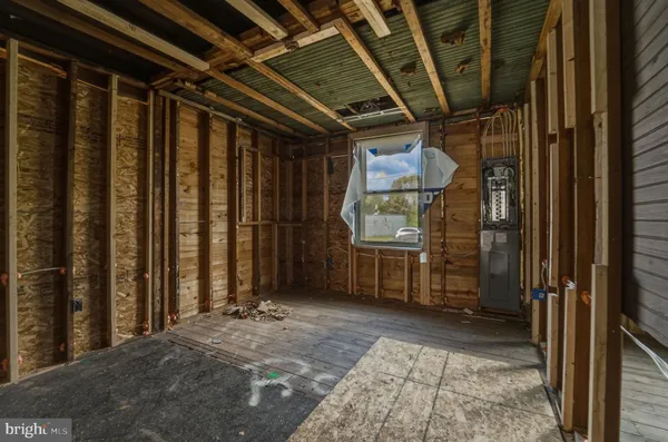 a view of a porch with wooden floor and a fireplace