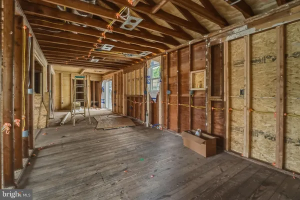 a view of a hallway with wooden walls