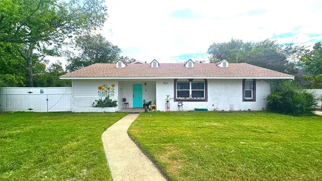 a front view of a house with a garden and porch