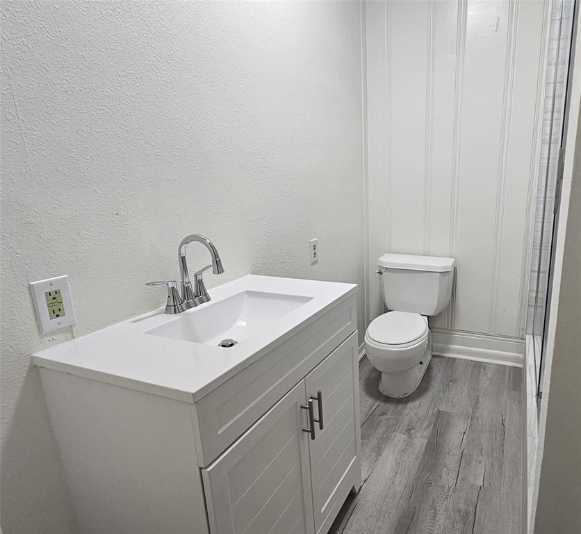 1015 South Welch Street, Unit A Denton, TX 76201 - Photo 11 of 21 a bathroom with a toilet sink and mirror
