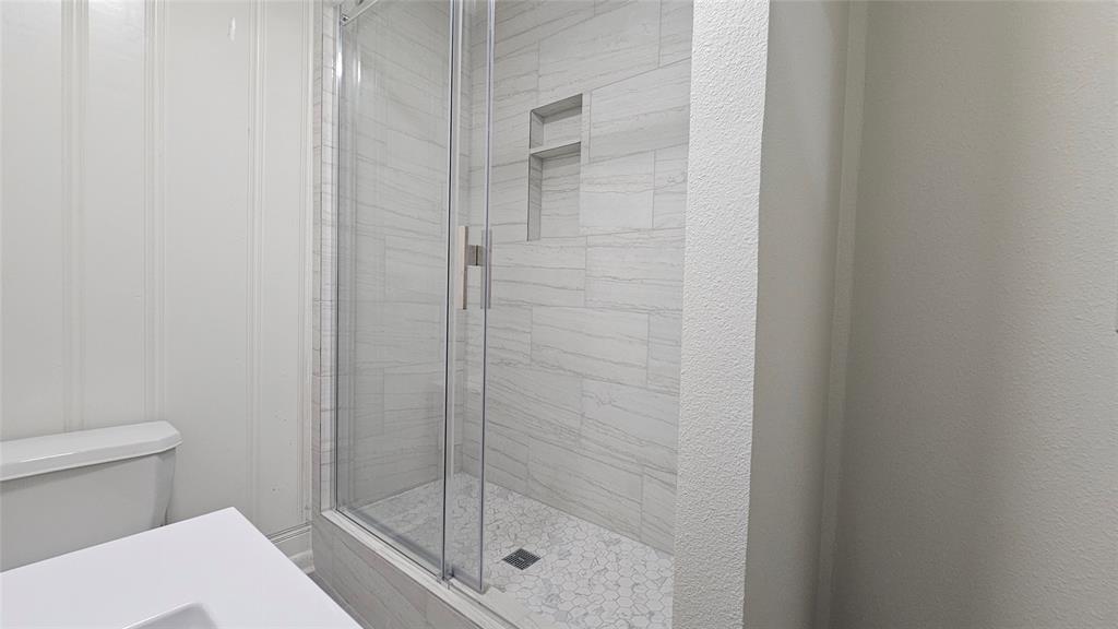 1015 South Welch Street, Unit A Denton, TX 76201 - Photo 12 of 21 a bathroom with a shower and a toilet