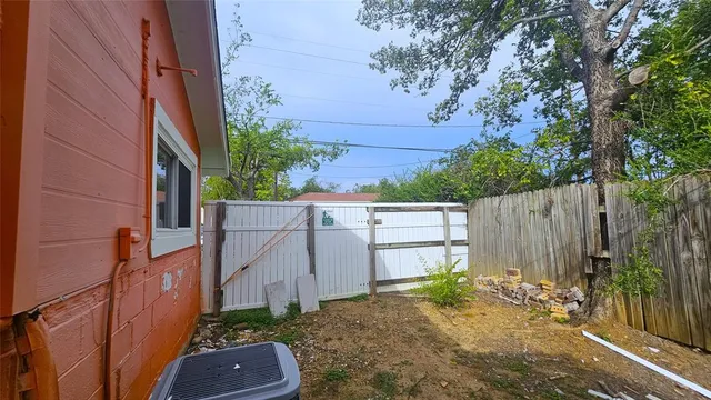 a backyard of a house with barbeque oven