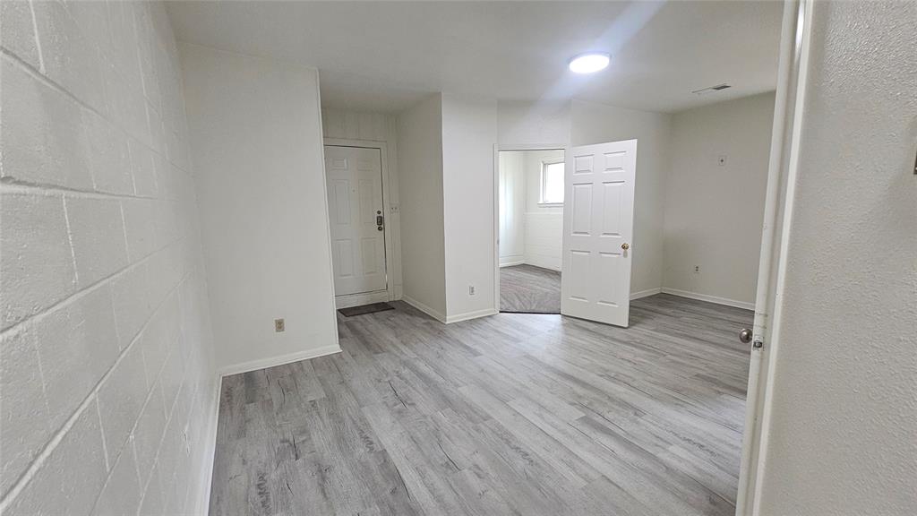 1015 South Welch Street, Unit A Denton, TX 76201 - Photo 3 of 21 wooden floor in an empty room with wooden floor