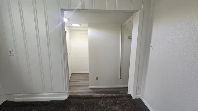 a view of a hallway and wooden floor