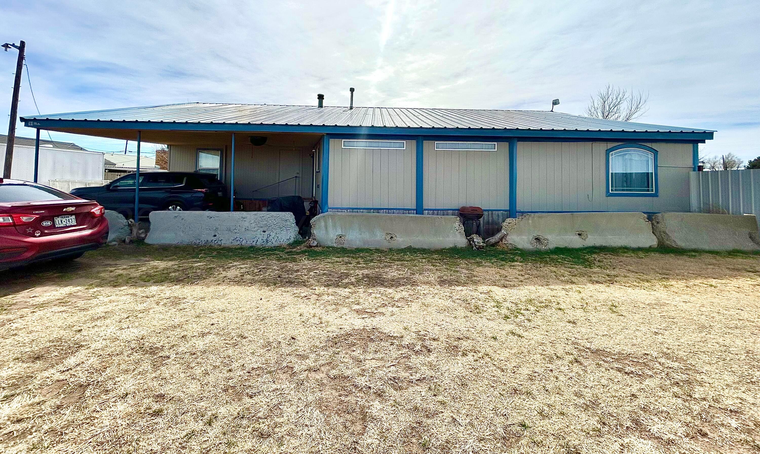 101 Gaines Street Claude, TX 79019 - Photo 1 of 18 a front view of a house with garden