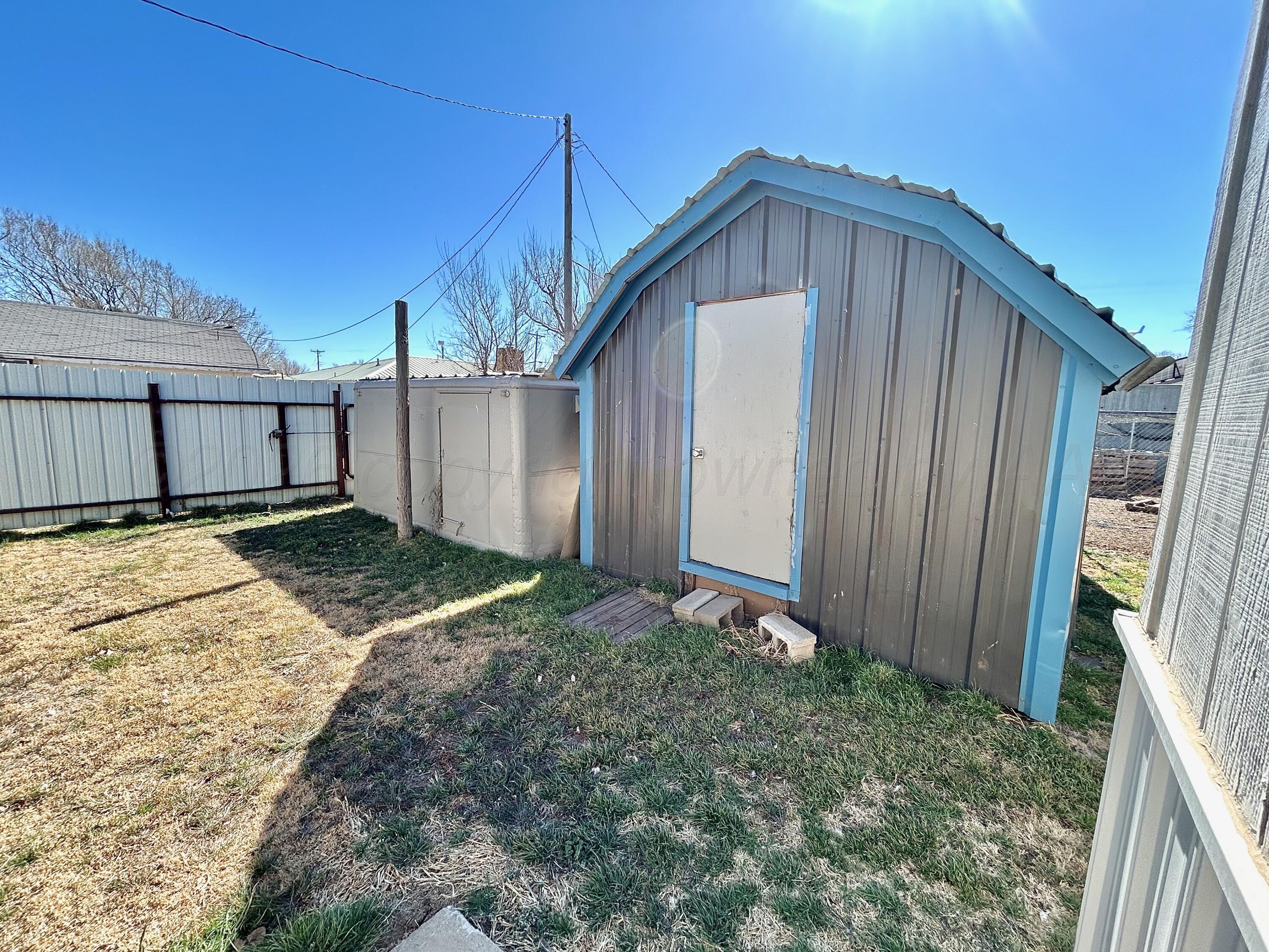 101 Gaines Street Claude, TX 79019 - Photo 16 of 18 a front view of a house with garden