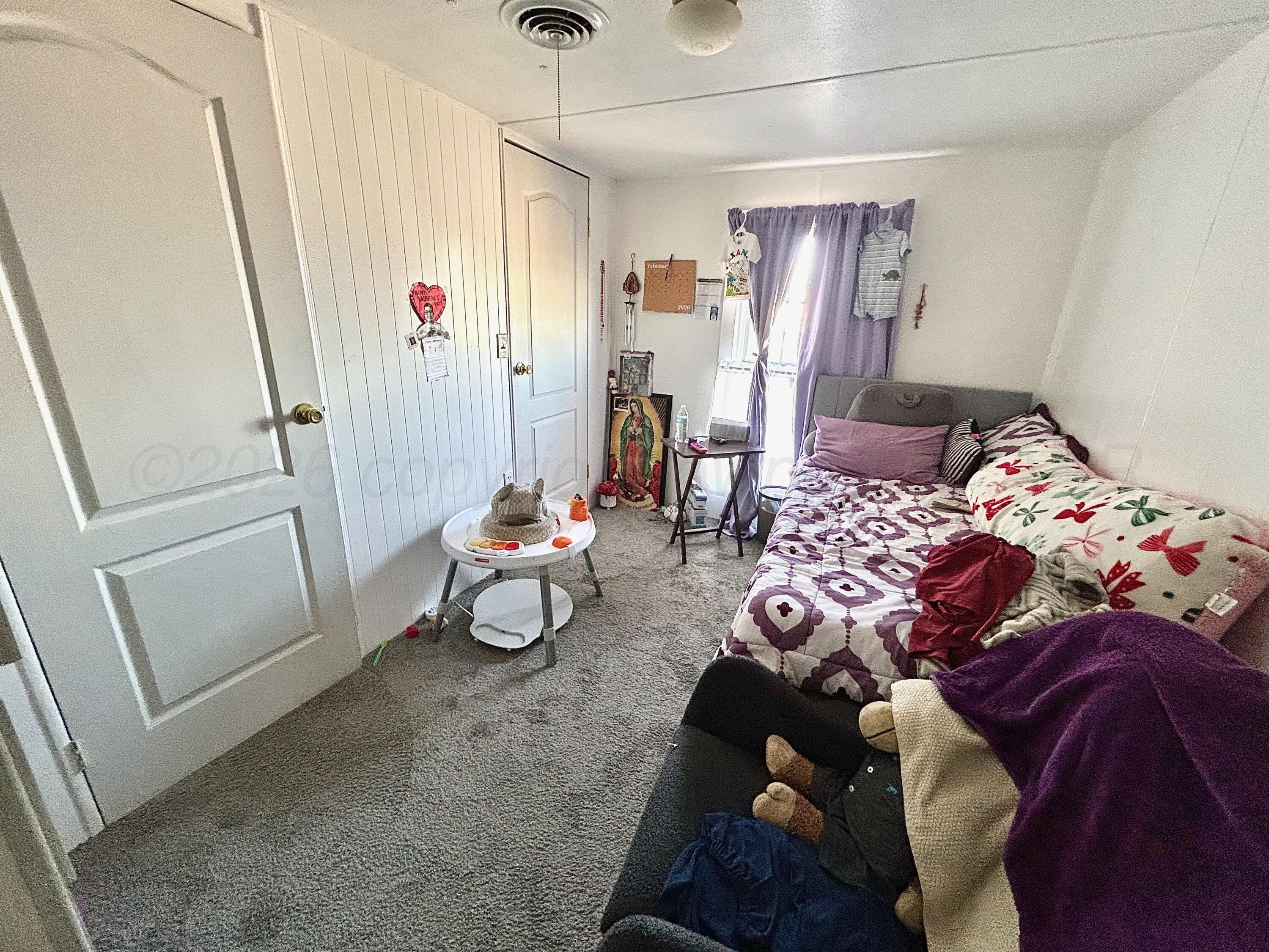 101 Gaines Street Claude, TX 79019 - Photo 7 of 18 a bedroom with furniture and a window