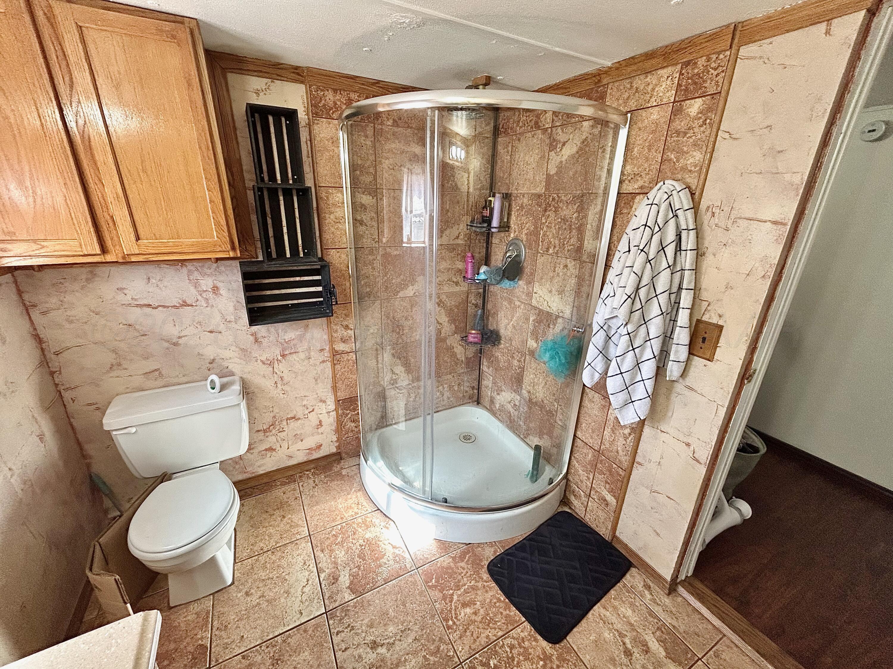 101 Gaines Street Claude, TX 79019 - Photo 10 of 18 a bathroom with a toilet and a shower