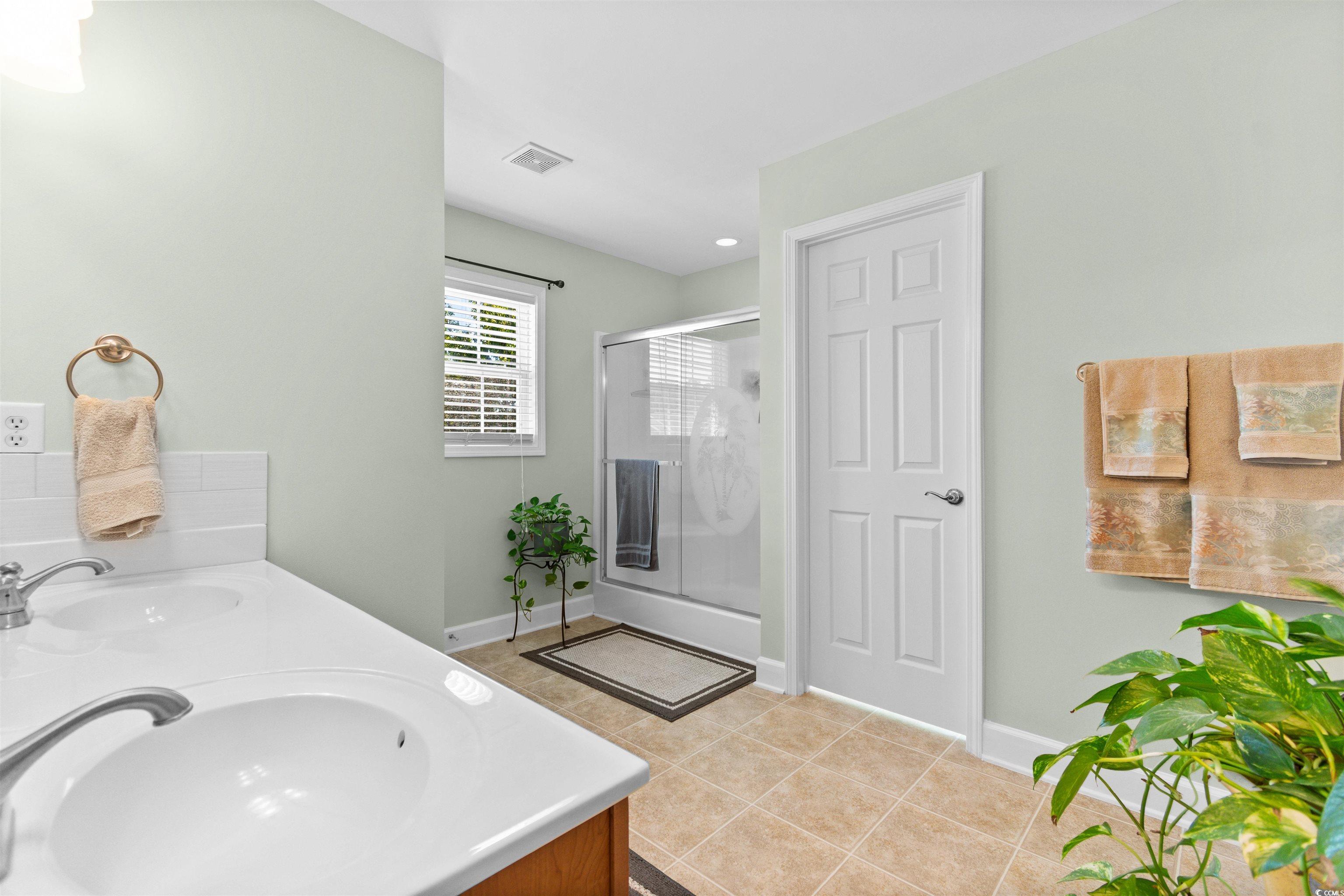 519 Heritage Point Drive Myrtle Beach, SC 29588 - Photo 18 of 39 Bathroom featuring double vanity, a shower stall, light tile patterned flooring, and recessed lighting