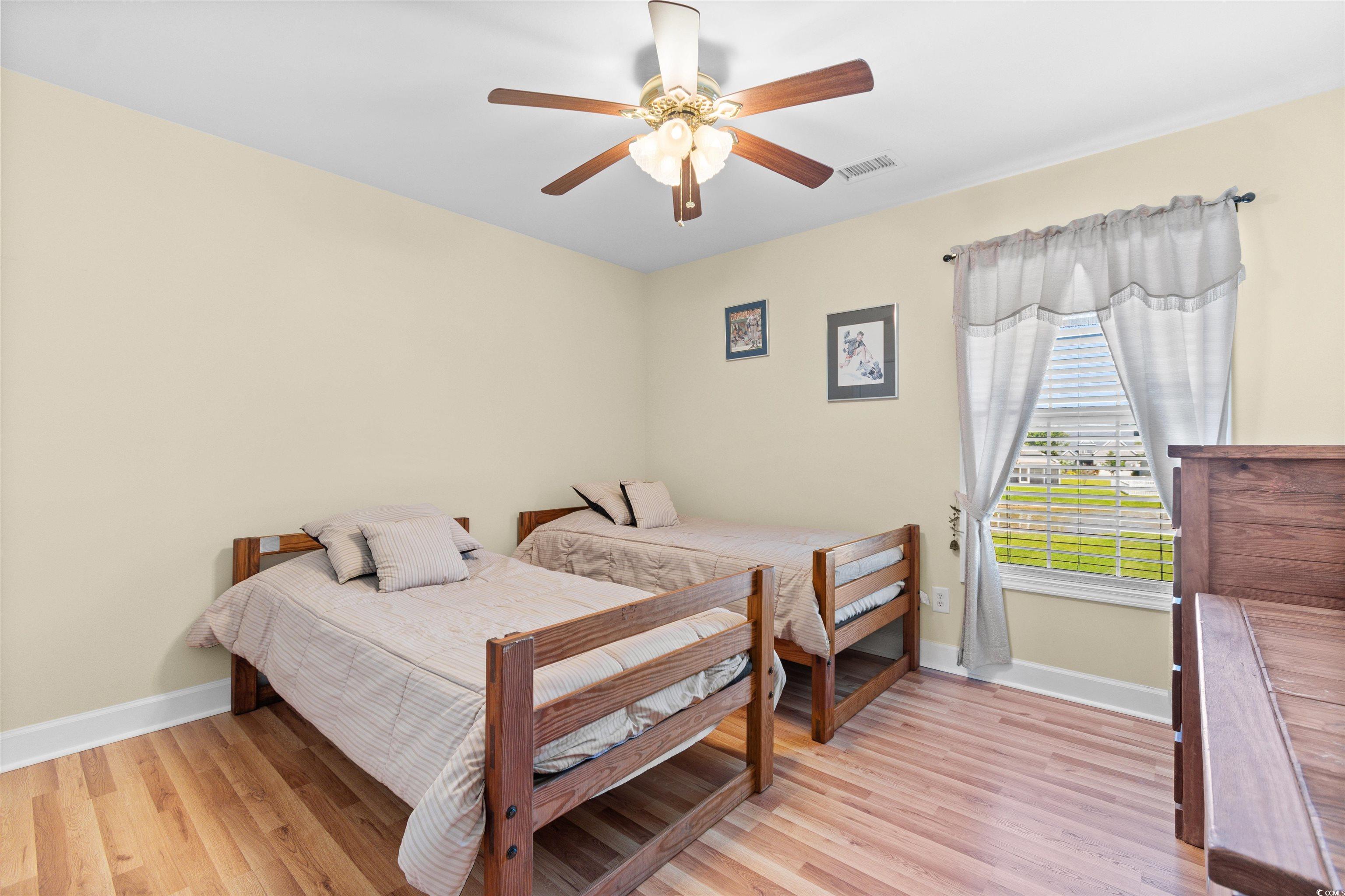 519 Heritage Point Drive Myrtle Beach, SC 29588 - Photo 20 of 39 Bedroom with light wood-style floors and a ceiling fan