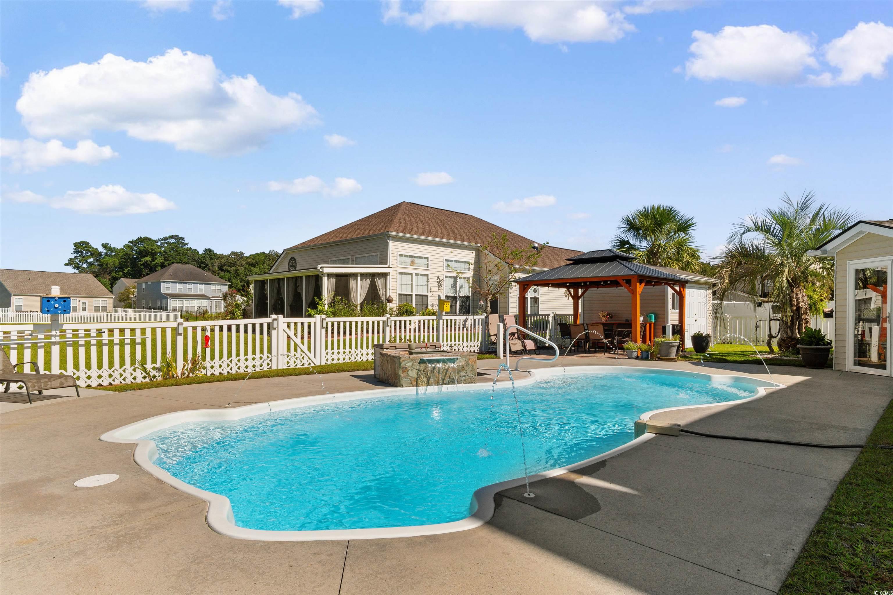 519 Heritage Point Drive Myrtle Beach, SC 29588 - Photo 27 of 39 View of pool featuring a gazebo, a patio area, an in-ground hot tub, and a residential view