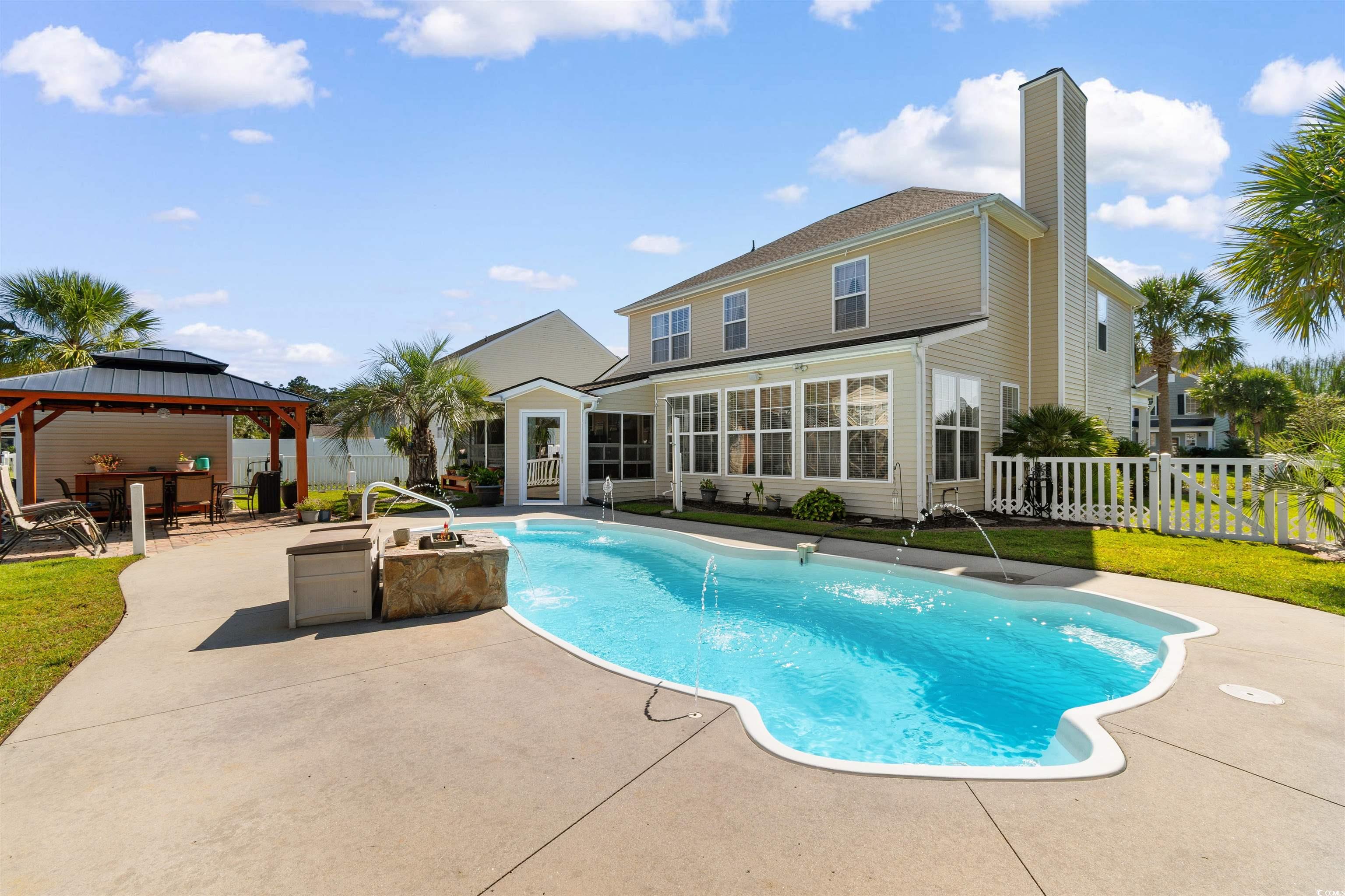 519 Heritage Point Drive Myrtle Beach, SC 29588 - Photo 28 of 39 View of pool with a patio area, a fenced backyard, and a gazebo