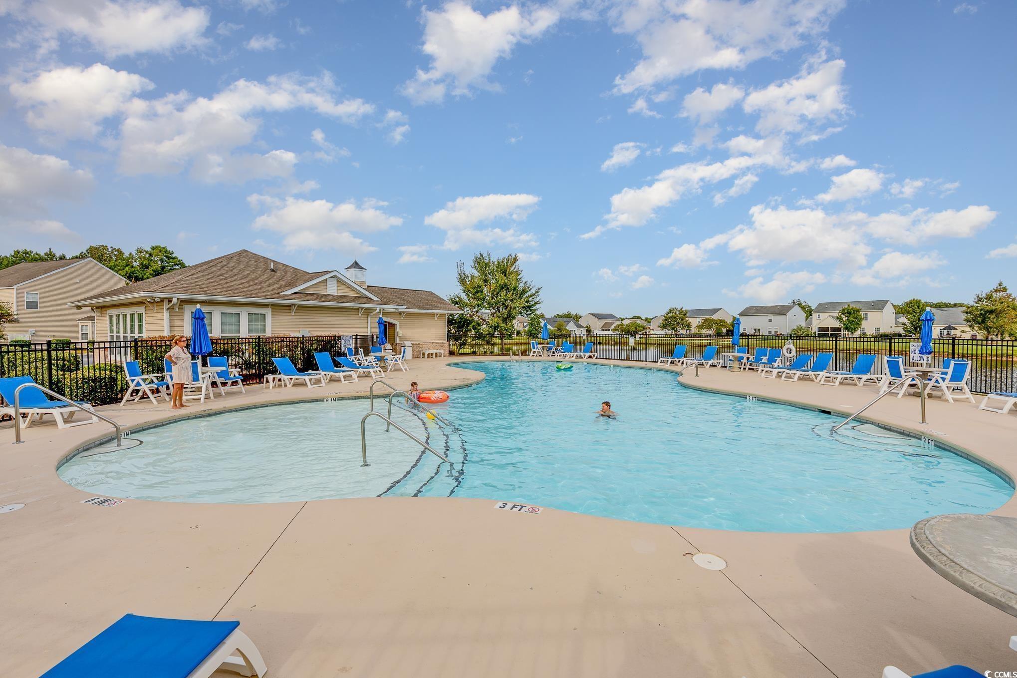 519 Heritage Point Drive Myrtle Beach, SC 29588 - Photo 33 of 39 Community pool featuring a patio and a residential view
