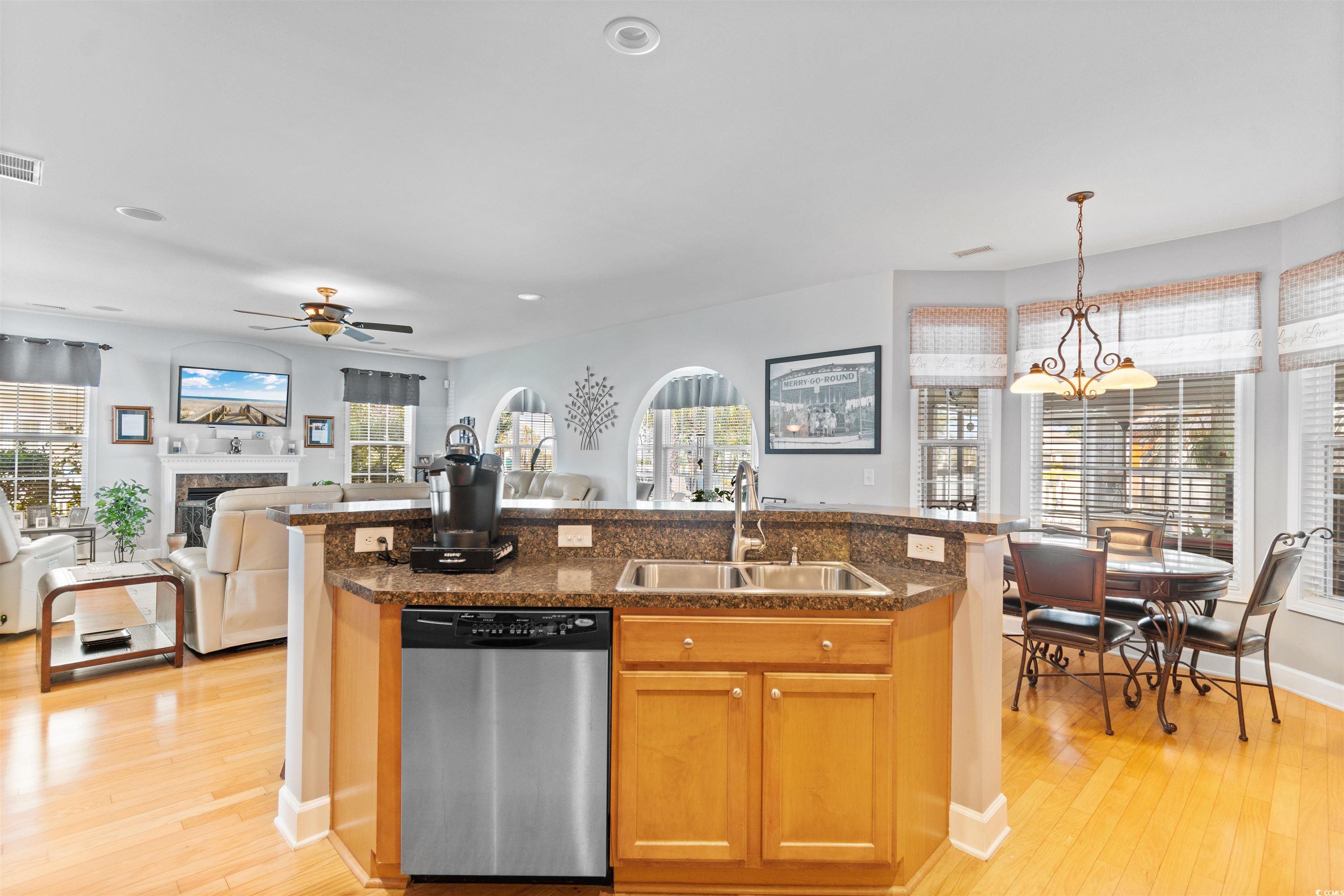 519 Heritage Point Drive Myrtle Beach, SC 29588 - Photo 38 of 39 Kitchen with an island with sink, stainless steel dishwasher, open floor plan, light wood-style flooring, and recessed lighting