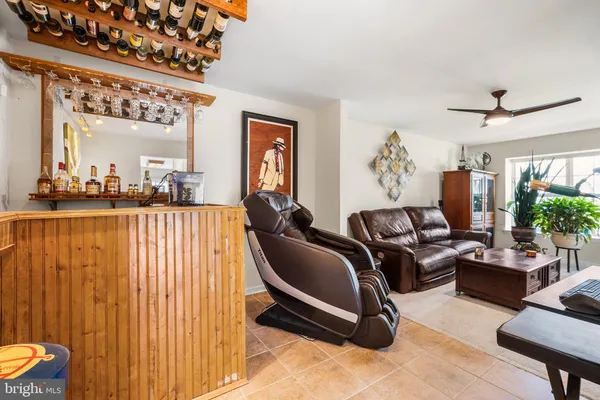 a living room with furniture a lamp and a potted plant
