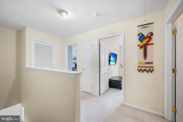 a view of hallway with furniture and refrigerator