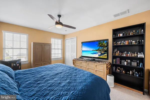 a bedroom with a bed cabinets and window