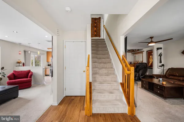 a view of a livingroom with furniture and stairs