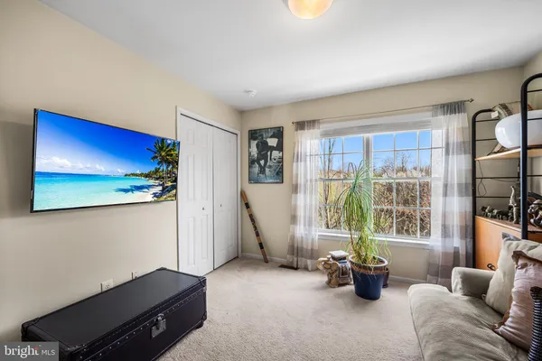 a living room with furniture gym equipment and large window