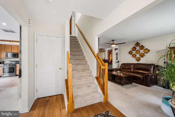 a view of entryway and hall with wooden floor