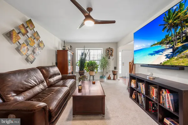 a living room with furniture fireplace and a large window