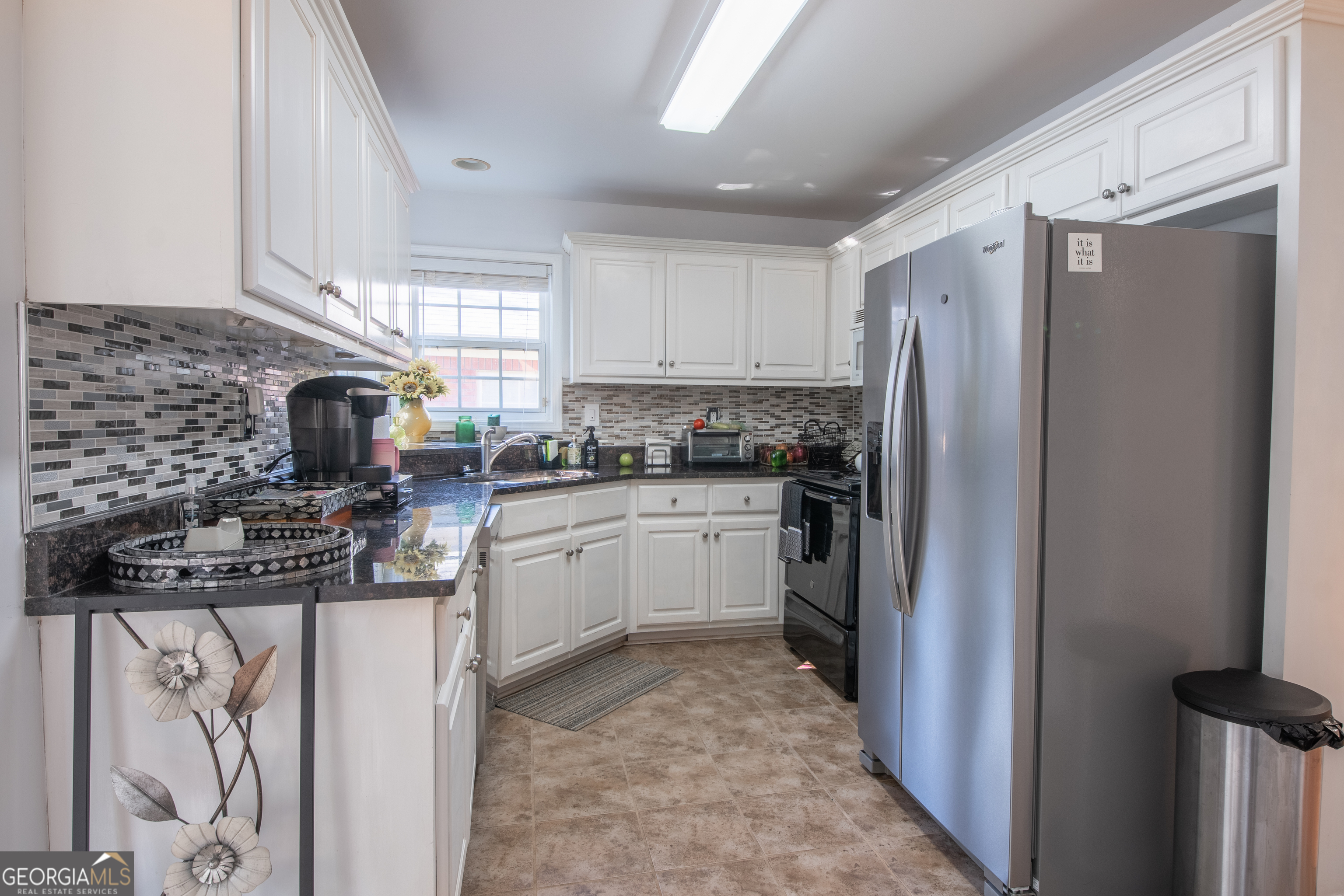 117 Covington Place Athens, GA 30606 - Photo 8 of 33 a kitchen with a refrigerator sink and stove