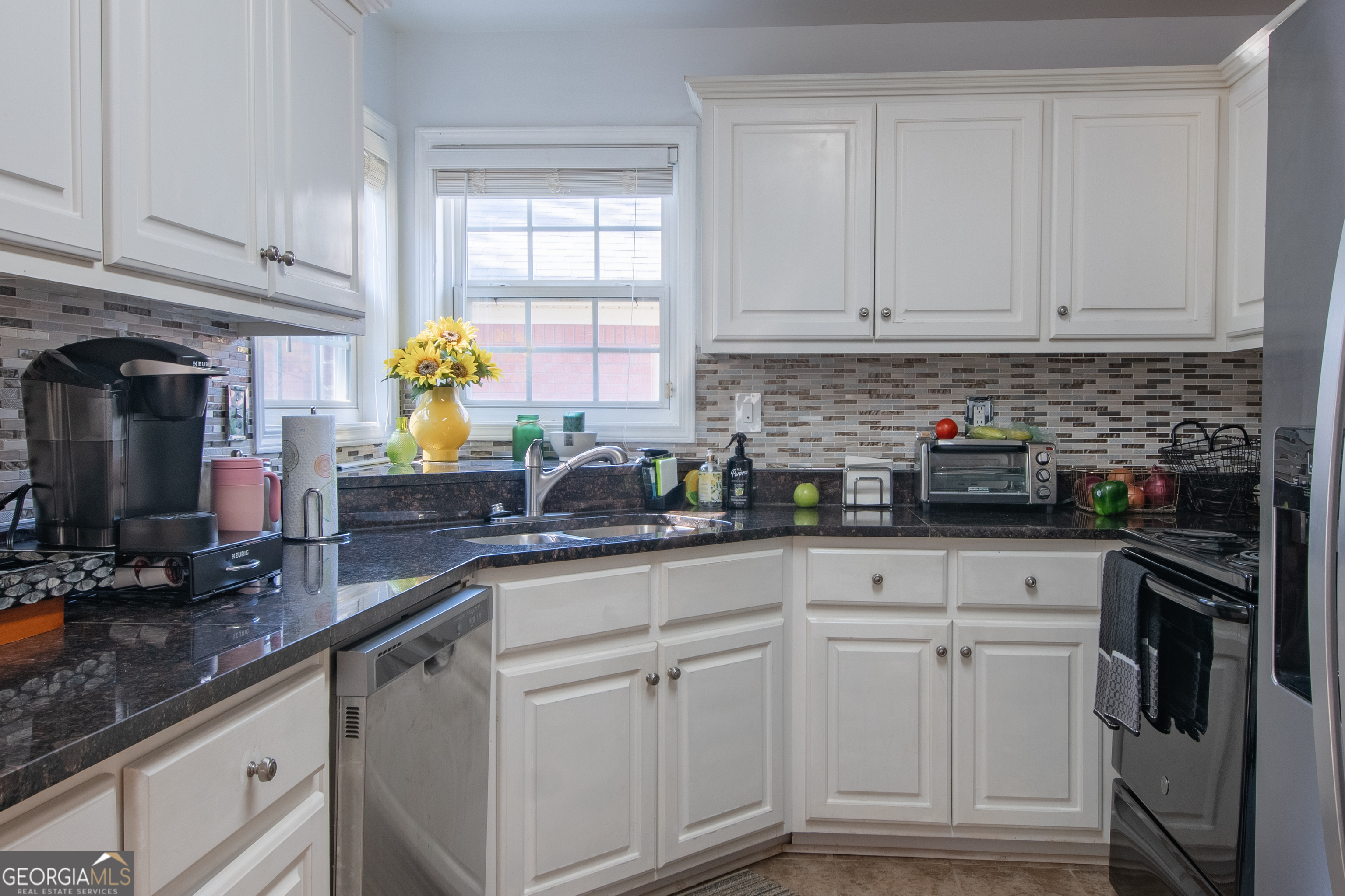 117 Covington Place Athens, GA 30606 - Photo 9 of 33 a kitchen with white cabinets and appliances