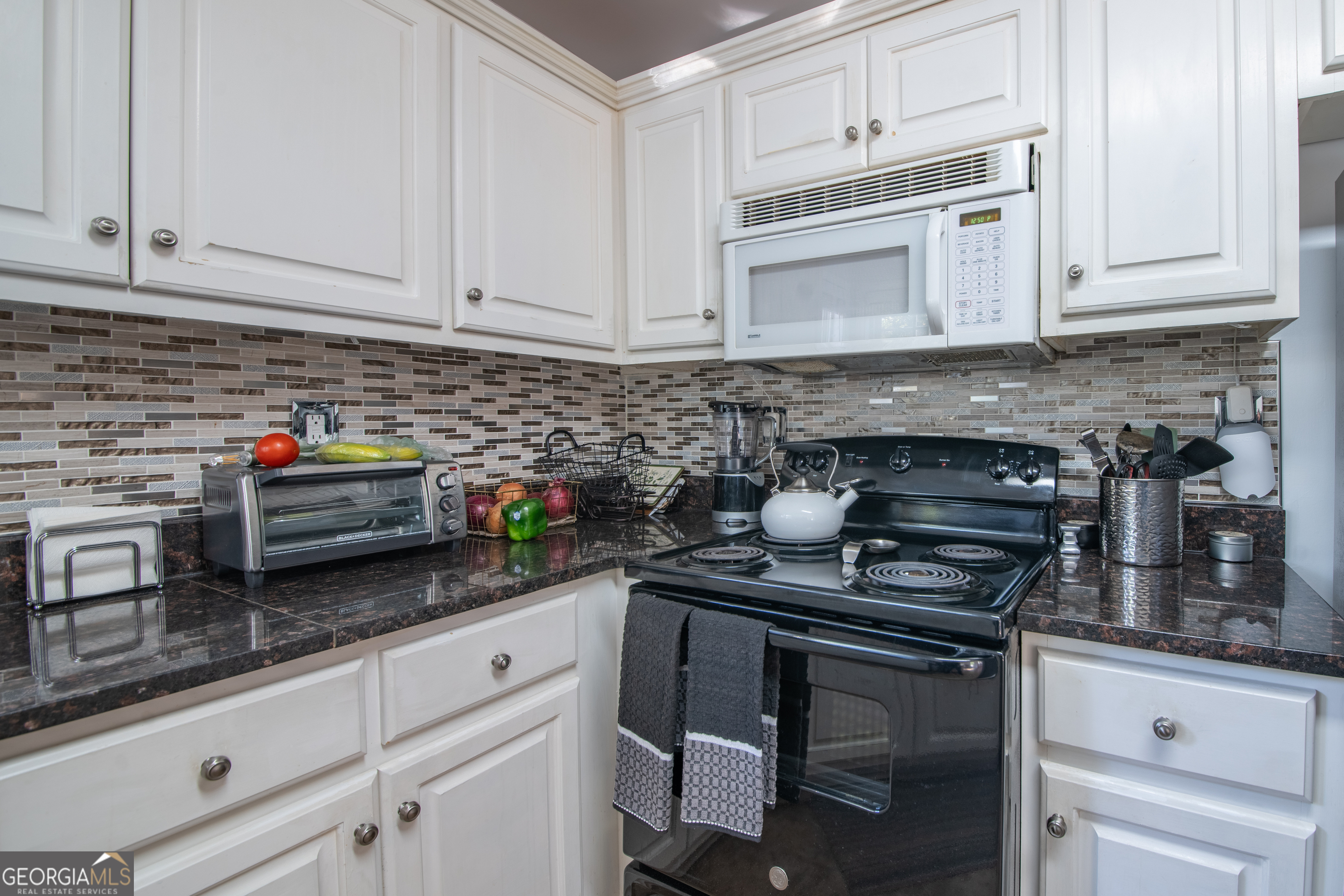 117 Covington Place Athens, GA 30606 - Photo 10 of 33 a kitchen with granite countertop white cabinets and white appliances
