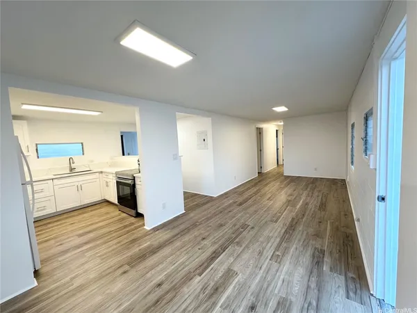 a view of a kitchen with wooden floor