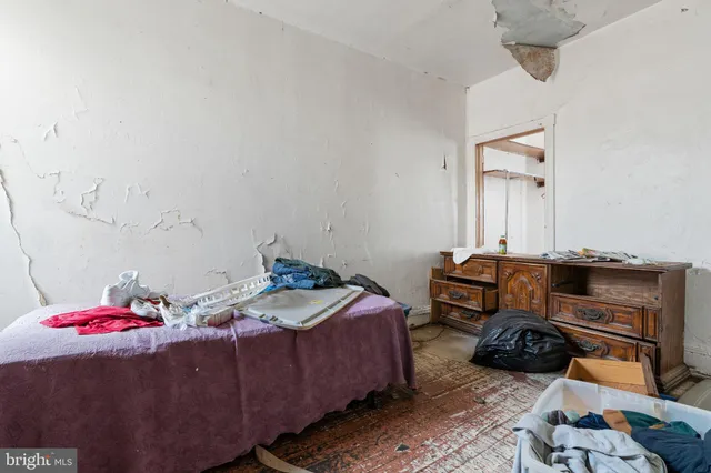 a bedroom with a bed and a mirror