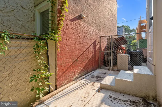 a room with water heater and a wooden door