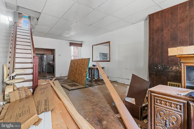 a view of a room with wooden floor and furniture