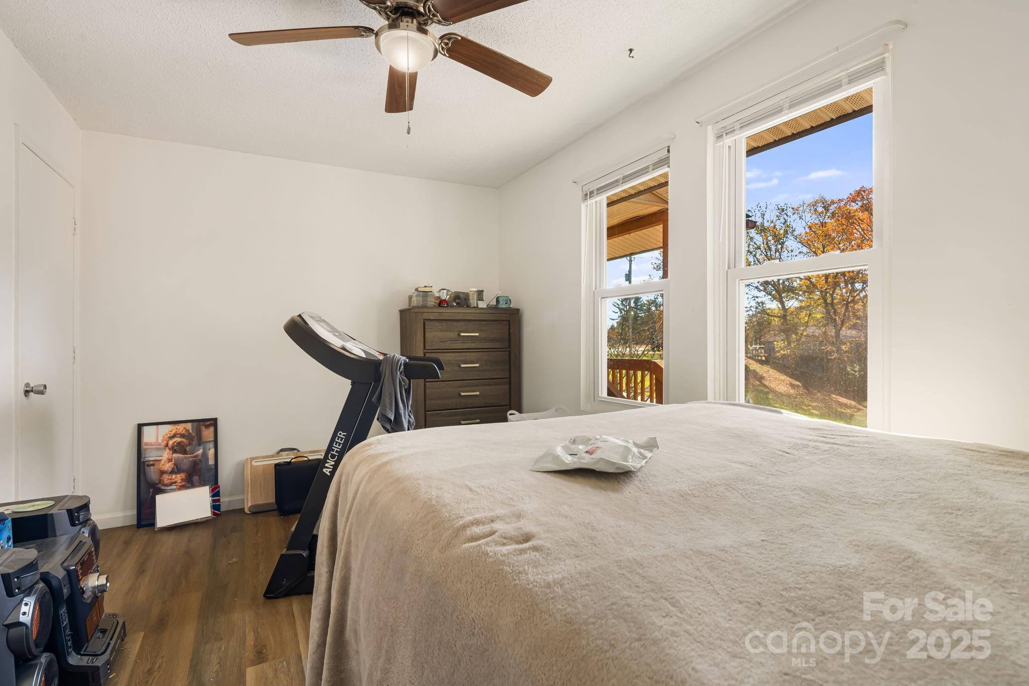 645 Flint Hill Road Alexander, NC 28701 - Photo 12 of 30 a bedroom with a bed and wooden floor