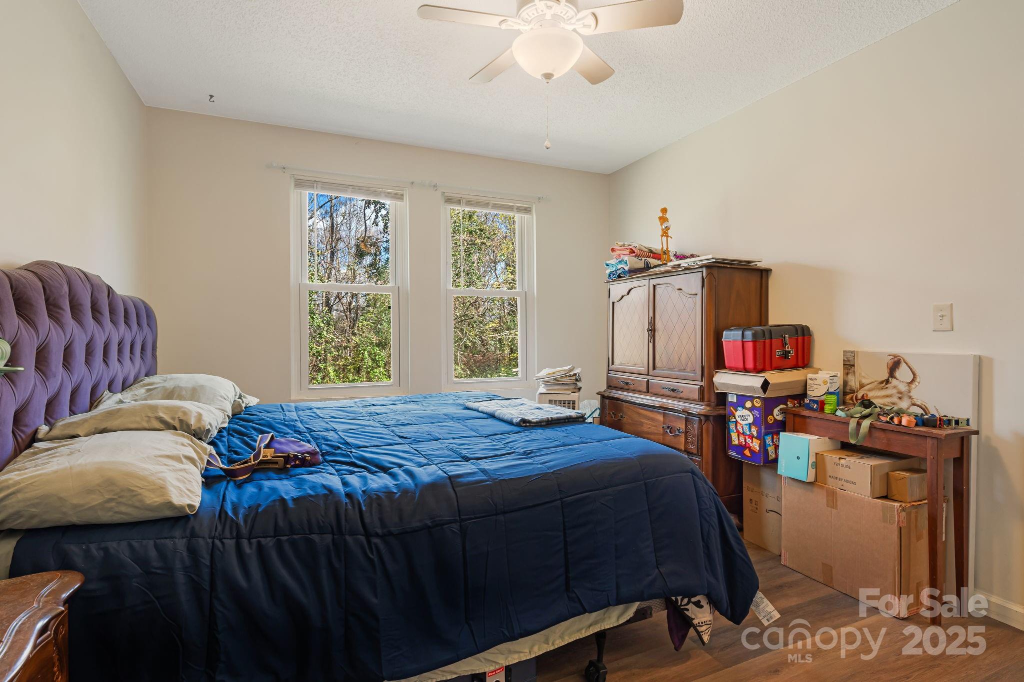 645 Flint Hill Road Alexander, NC 28701 - Photo 14 of 30 a bedroom with a bed and wooden floor