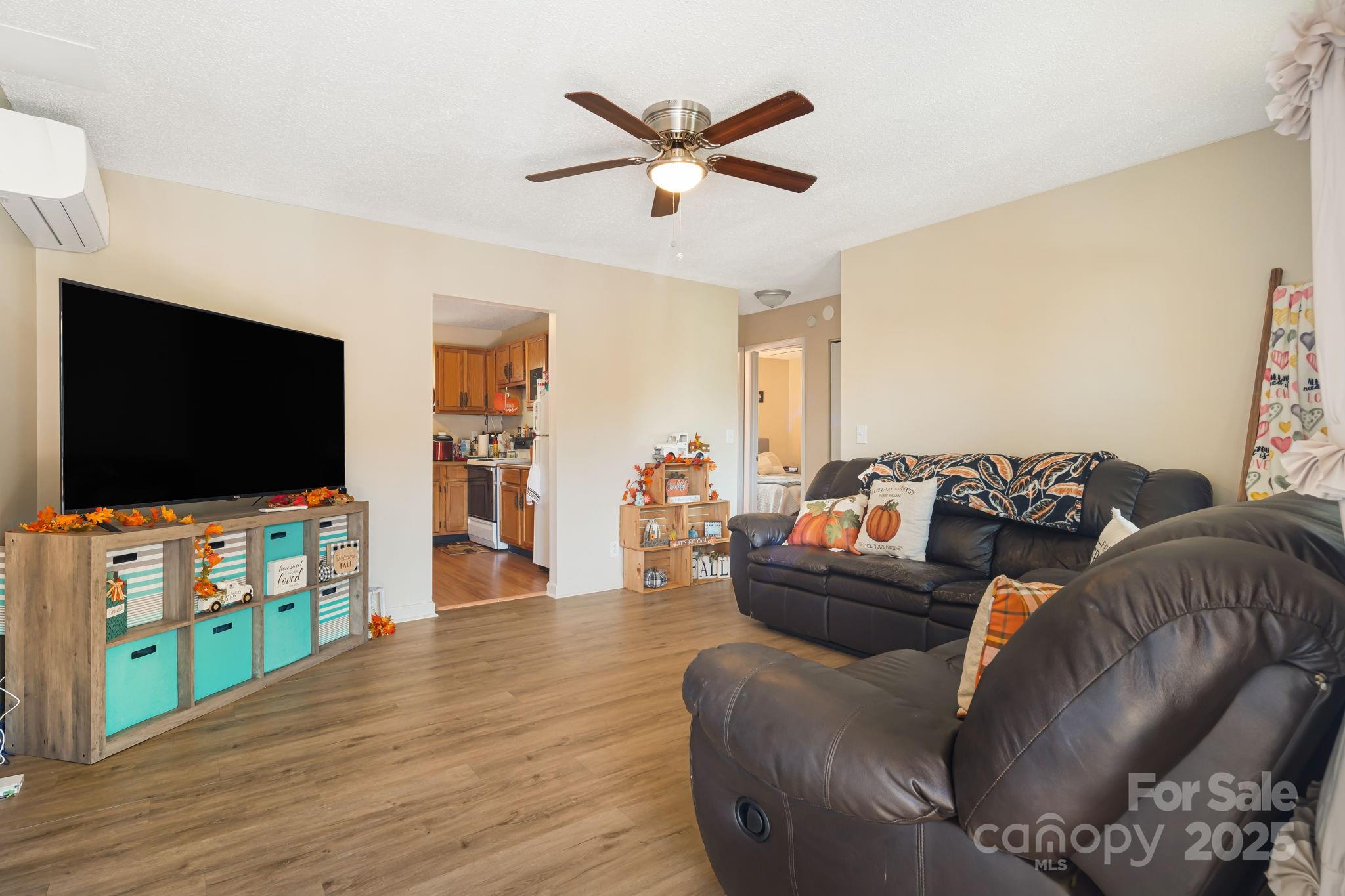 645 Flint Hill Road Alexander, NC 28701 - Photo 15 of 30 a living room with furniture and a flat screen tv